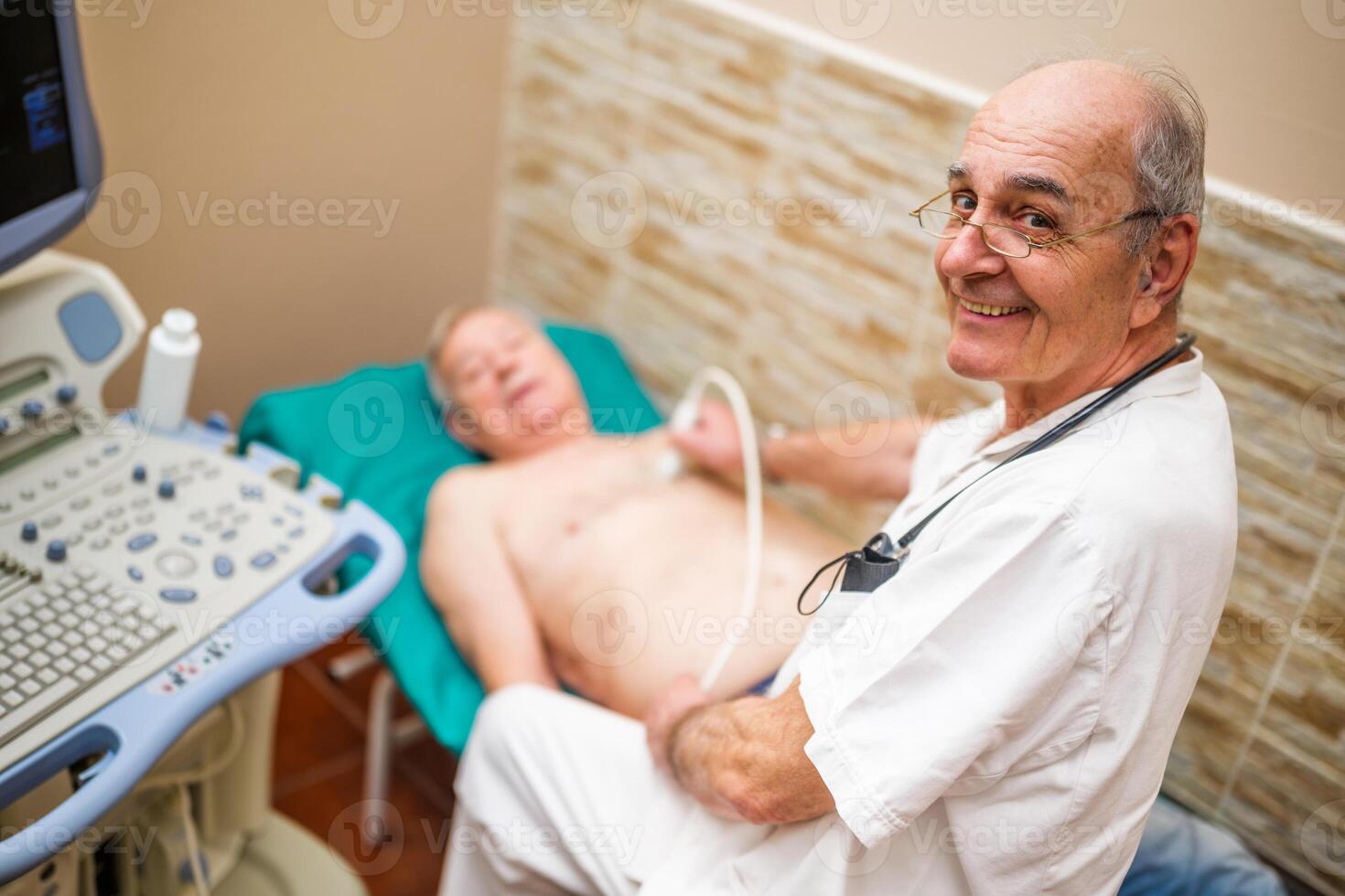 A doctor in a healthcare setting performs an ultrasound heart exam on a Caucasian senior patient, using advanced medical equipment. photo