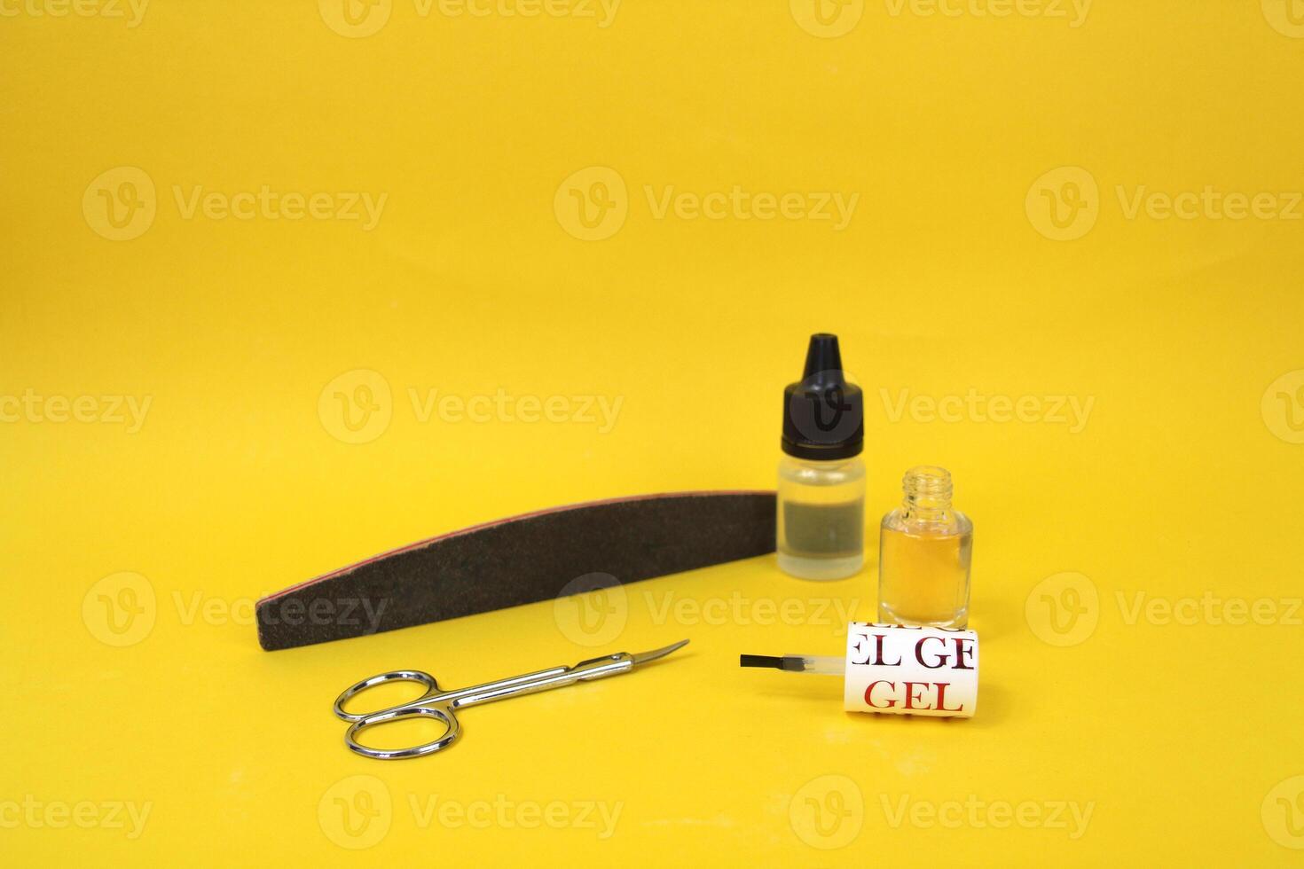 On a yellow background there are items for manicure, open nail polish photo