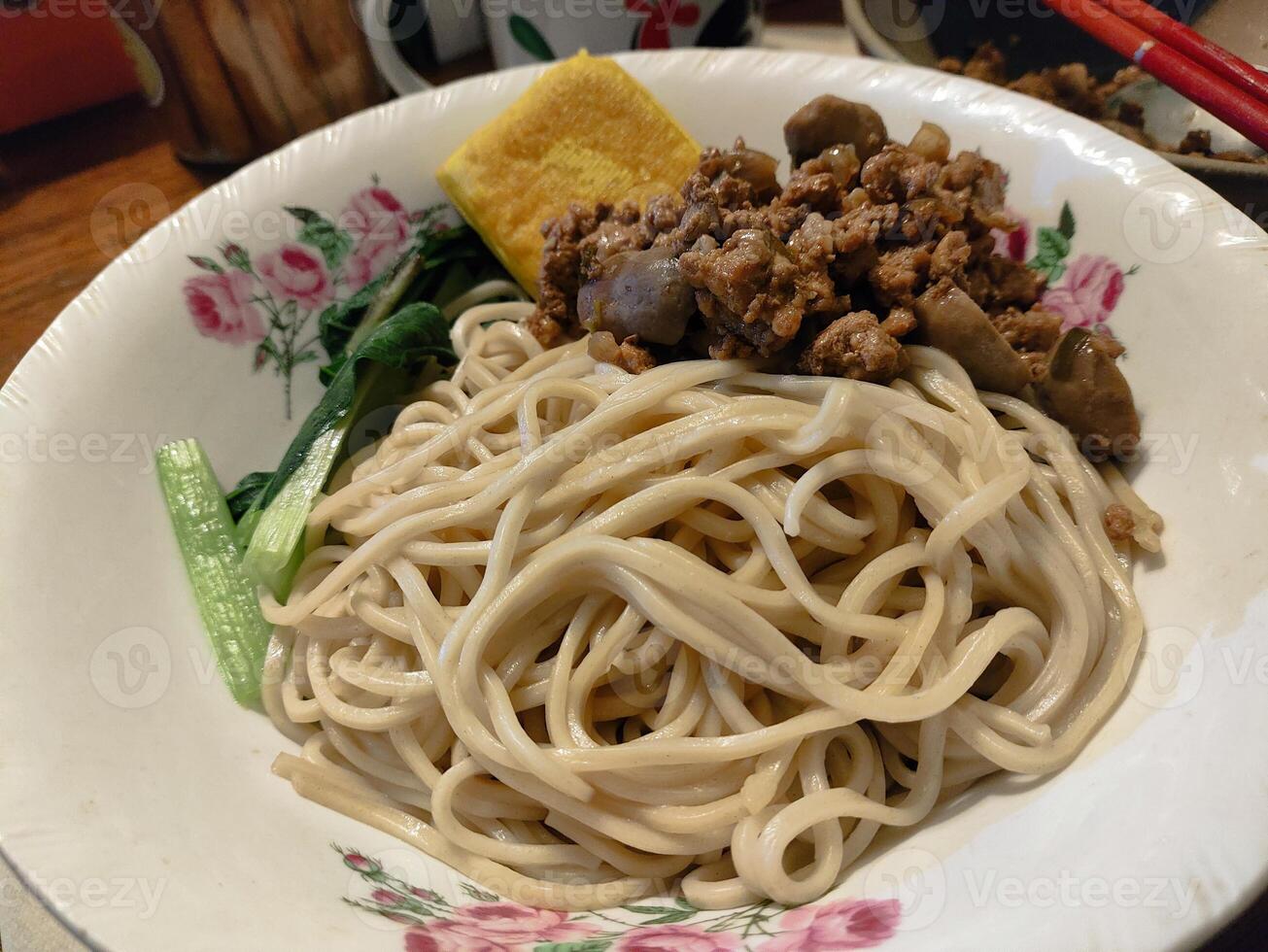 A bowl of noodles with meat and vegetables photo