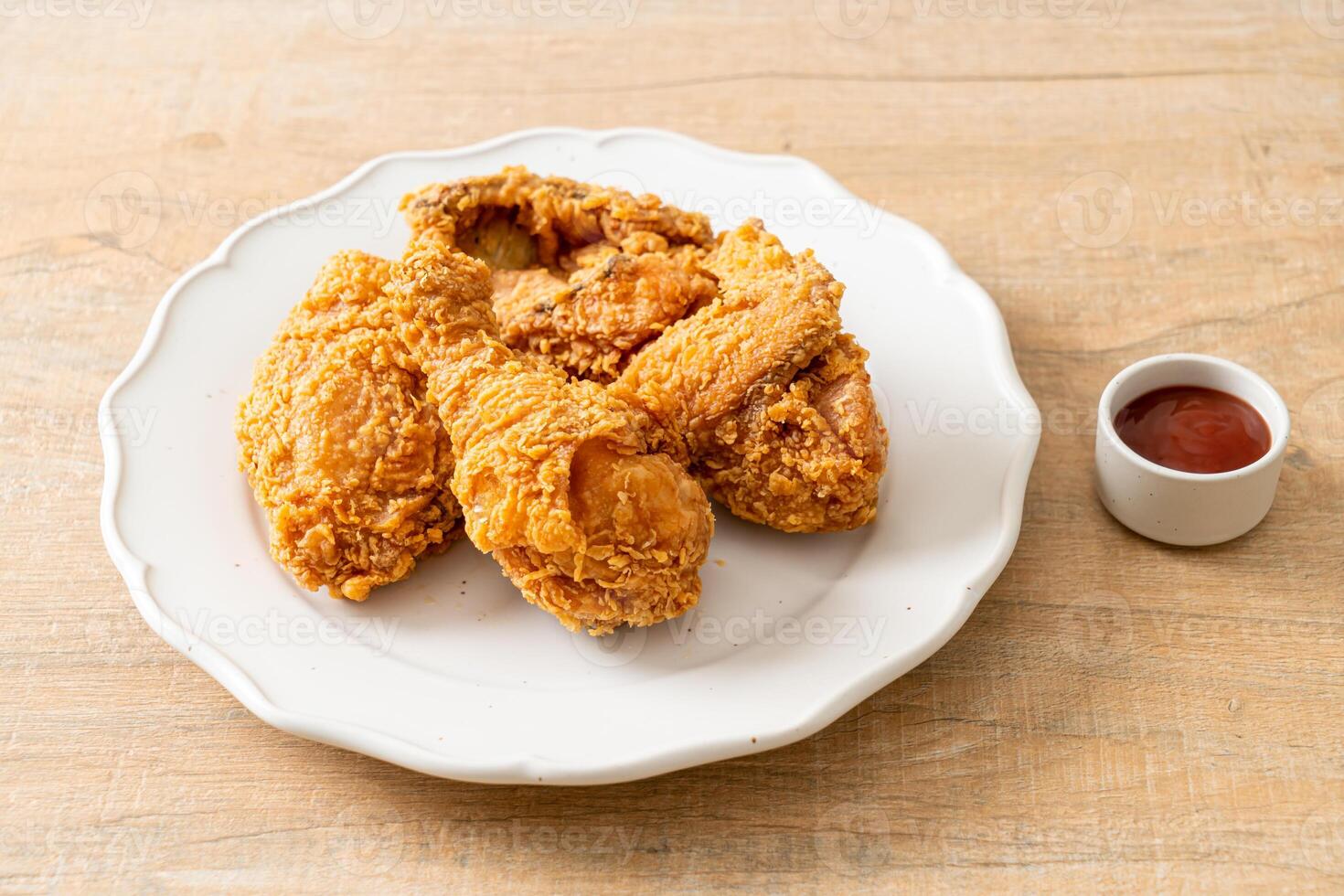fried chicken with ketchup on wood background photo
