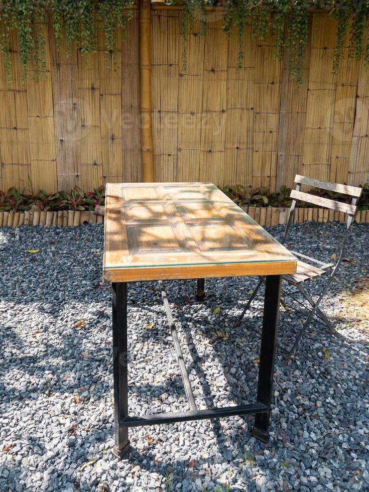 Rustic Wooden Table in Quaint Garden Cafe. photo