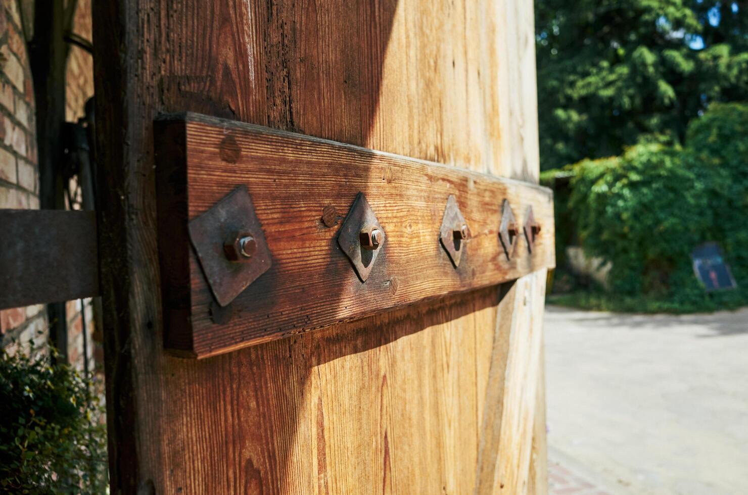 Wooden door has a metal bracket holding it up photo