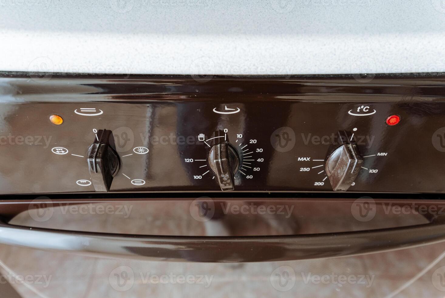 This image features a closeup view of a sleek black oven that is equipped with a prominent red light located at the top, enhancing its visibility and giving it a modern touch photo