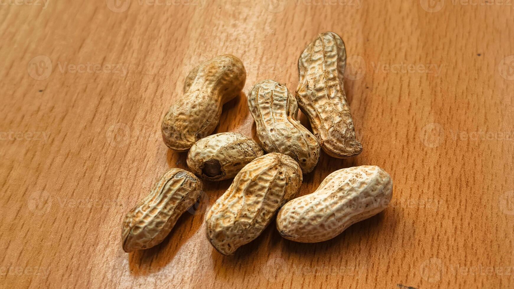 Roasted peanuts in shells on a rustic wooden table healthy snack food photo