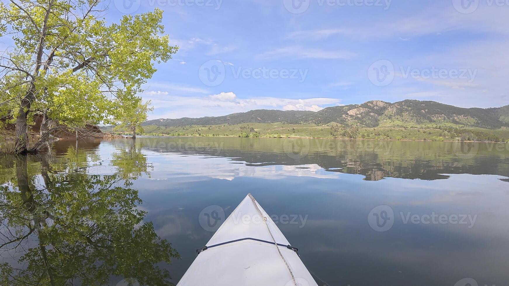spring kayaking canoeing on Horsetooth Reservoir at foothills of Rocky Mountains in Fort Collins, Colorado - POV paddler perspective photo