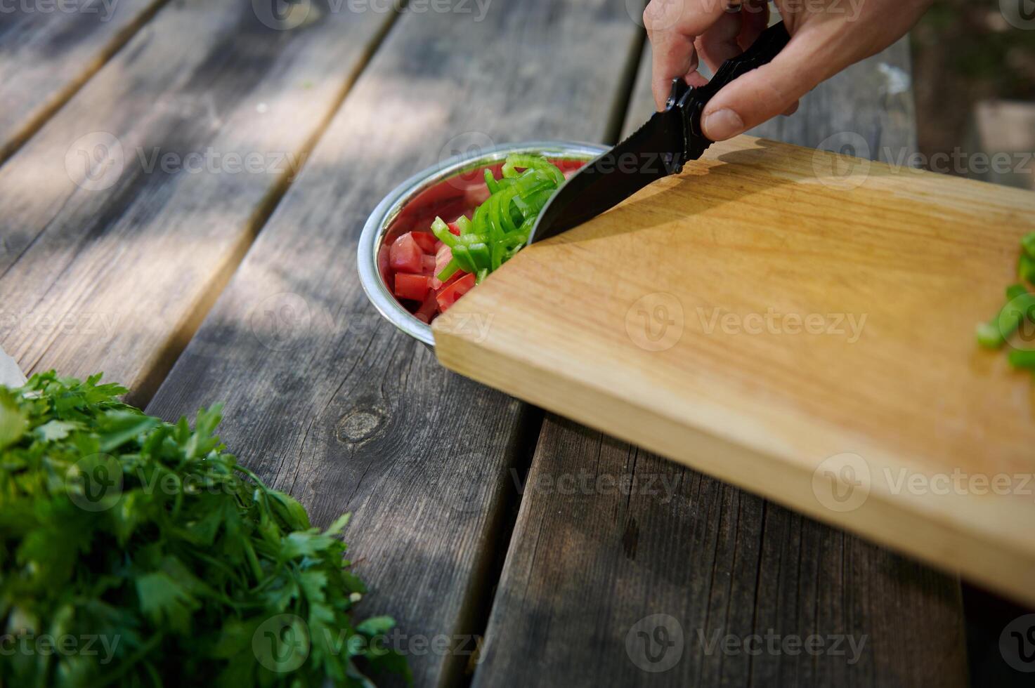 Outdoor Preparation of Fresh Salad Ingredients on Rustic Wooden Table photo