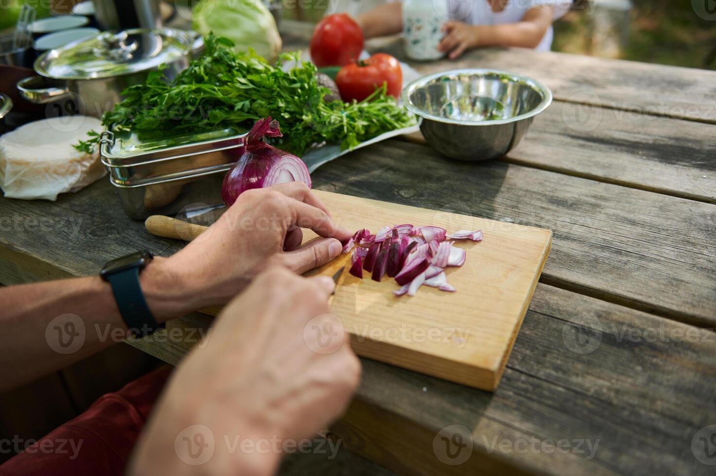 Preparation of Fresh Vegetables on Outdoor Wooden Picnic Table photo