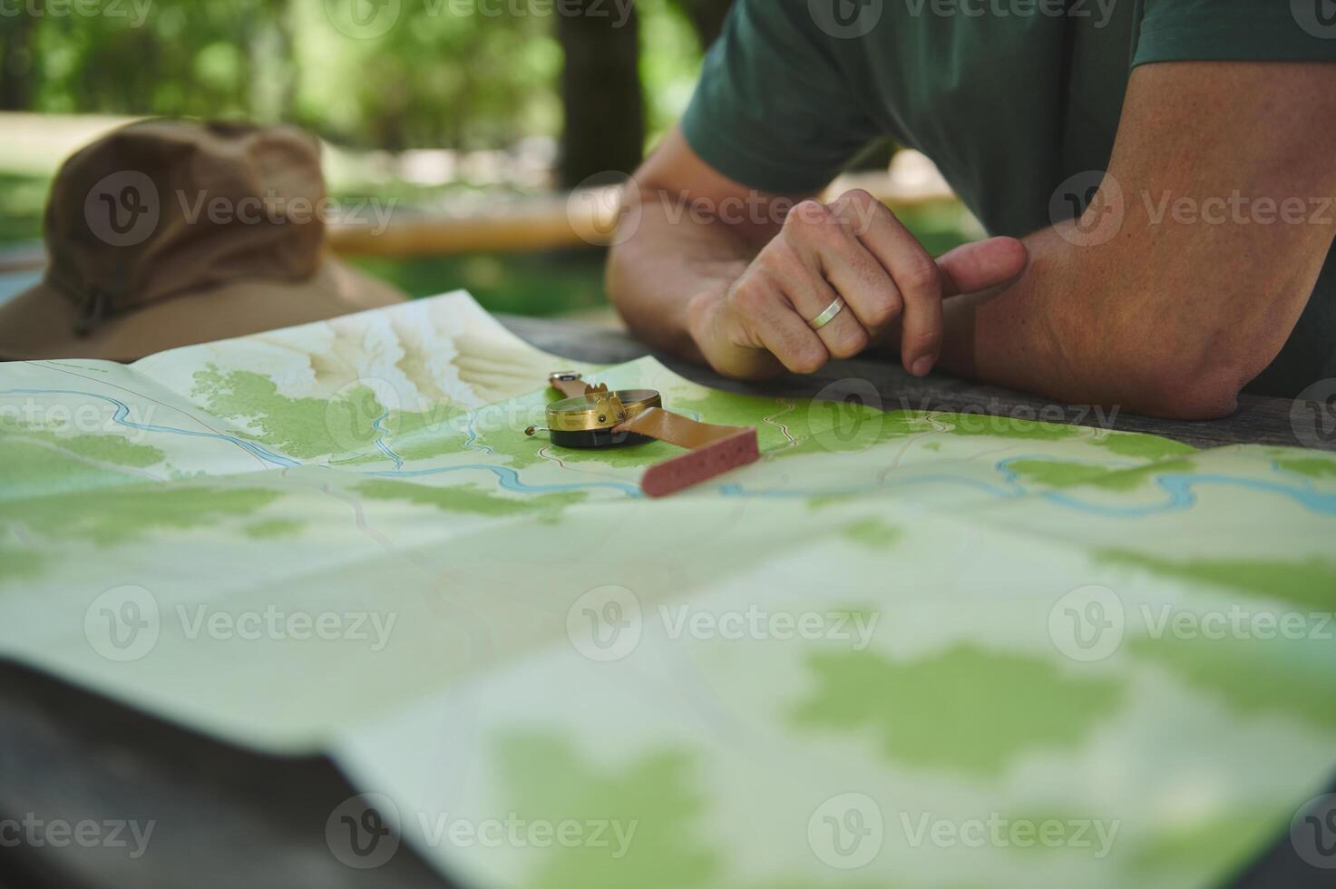 Exploring Nature With Map and Compass on a Wooden Table Outdoors photo