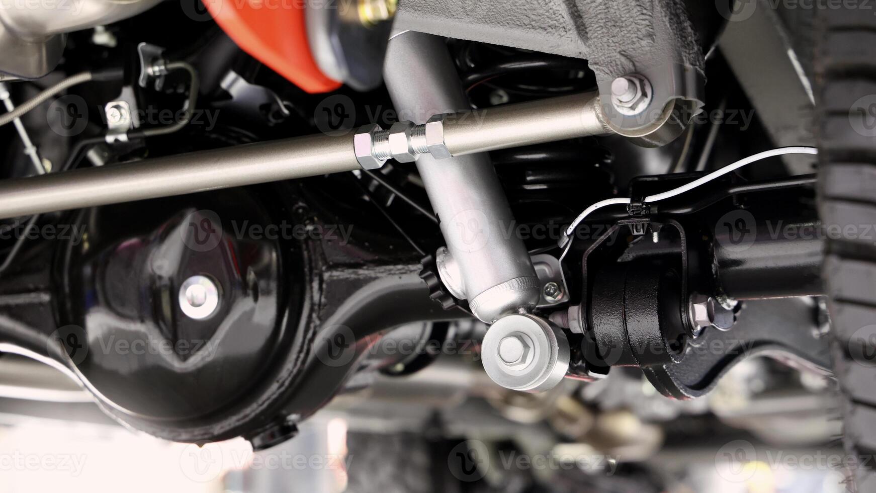 Car suspension part, Close up of a rear car suspension and exhaust system. photo
