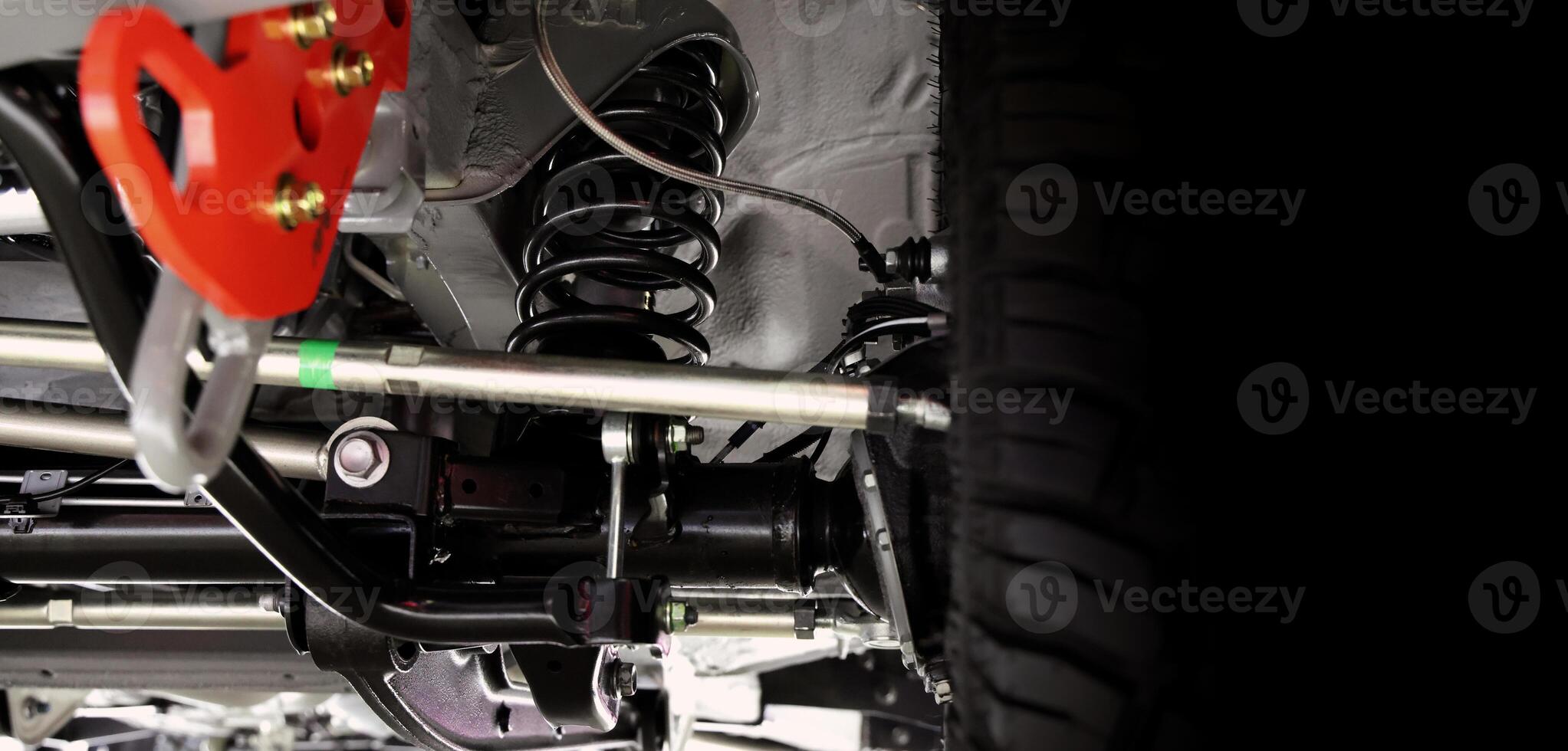 Car suspension part,, Close up of a rear car suspension and exhaust system. photo