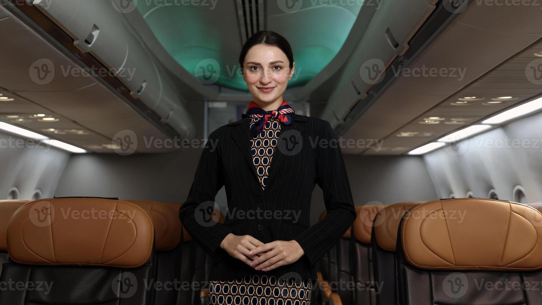 Friendly flight ,attendant stand confidently inside an airplane cabin. photo