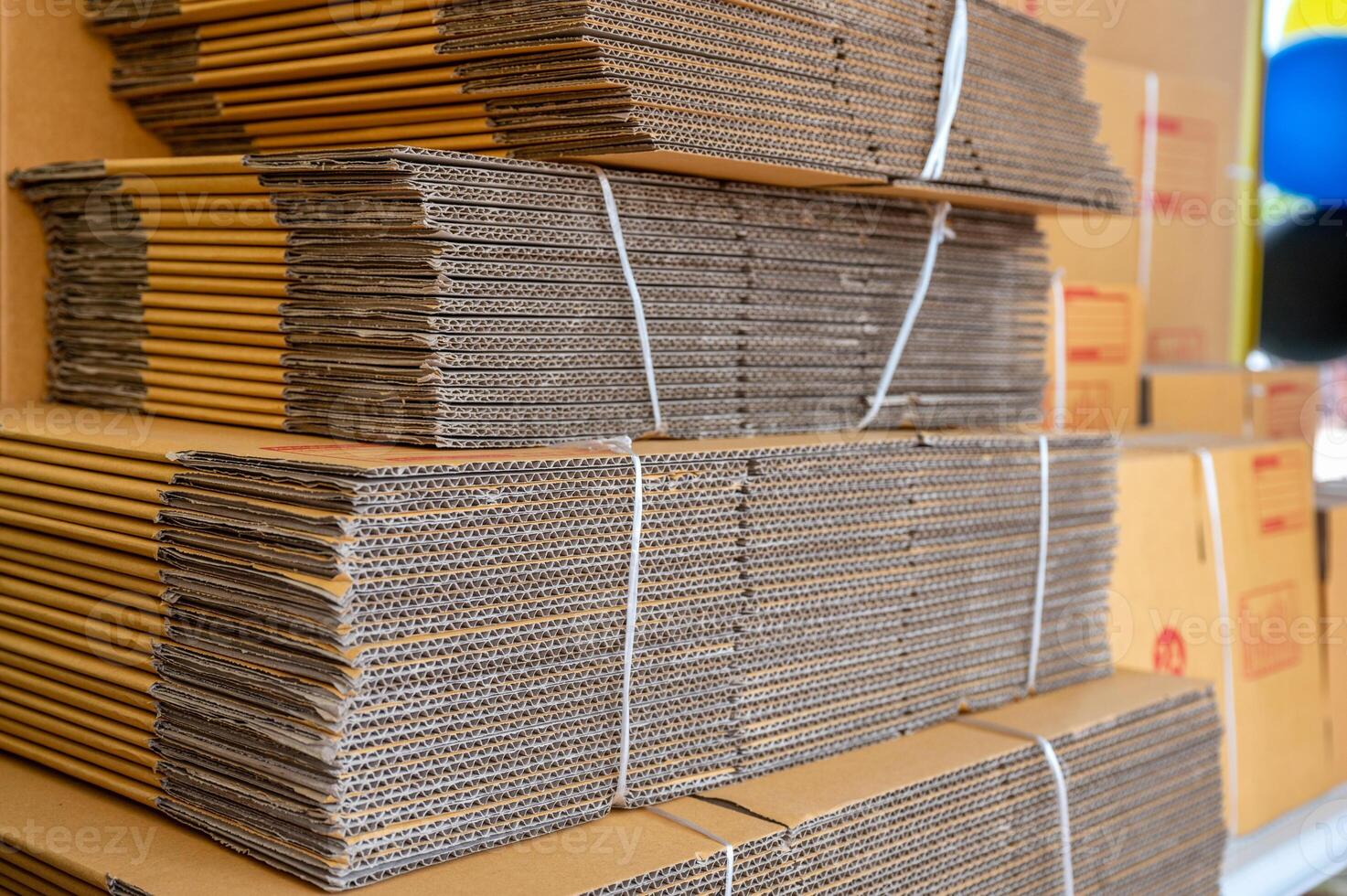 Stack of brown folded cardboard boxes tied photo