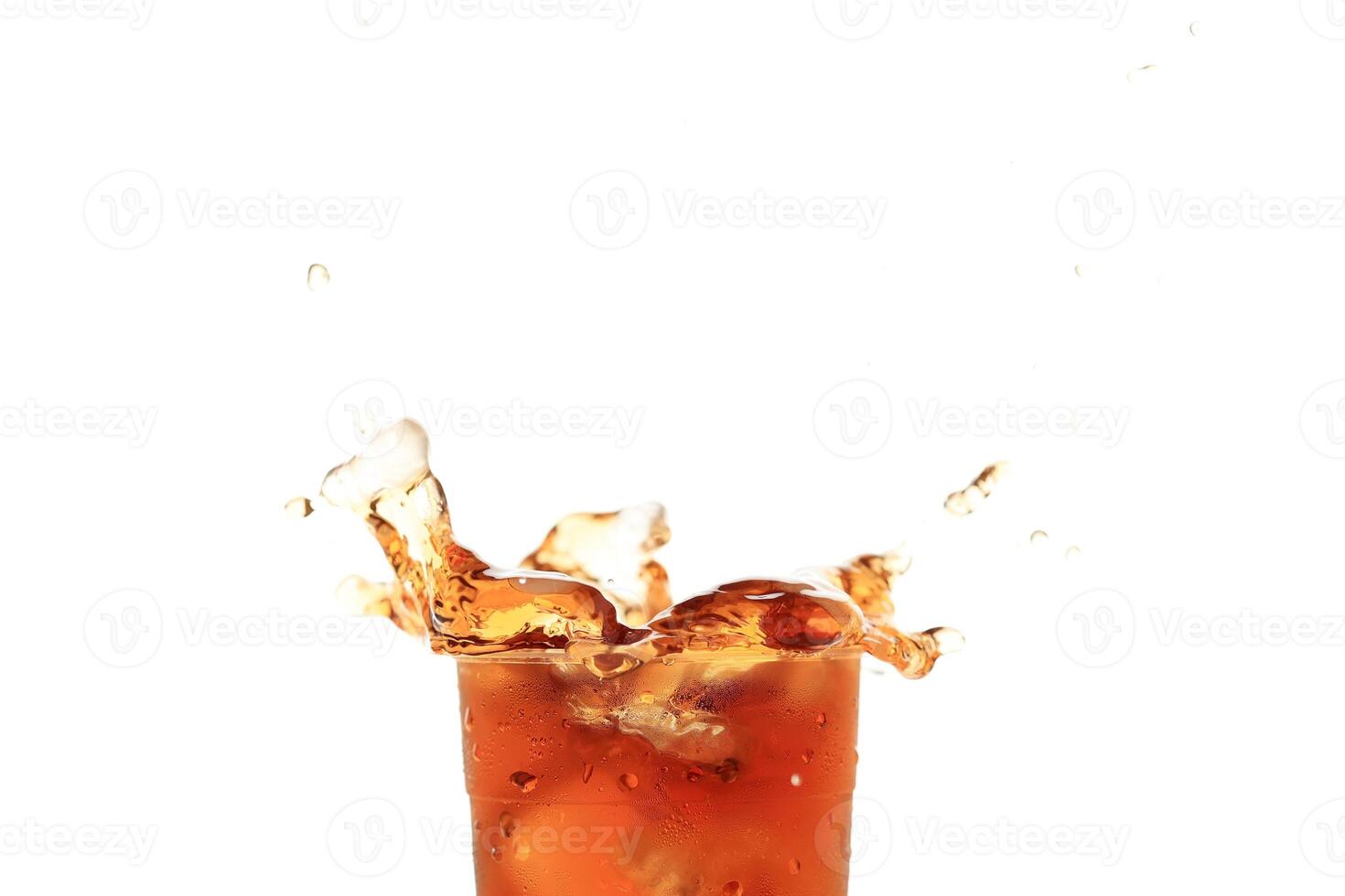 Close Up Splash of Iced Tea on Plastic Cup Isolated on White Background. photo
