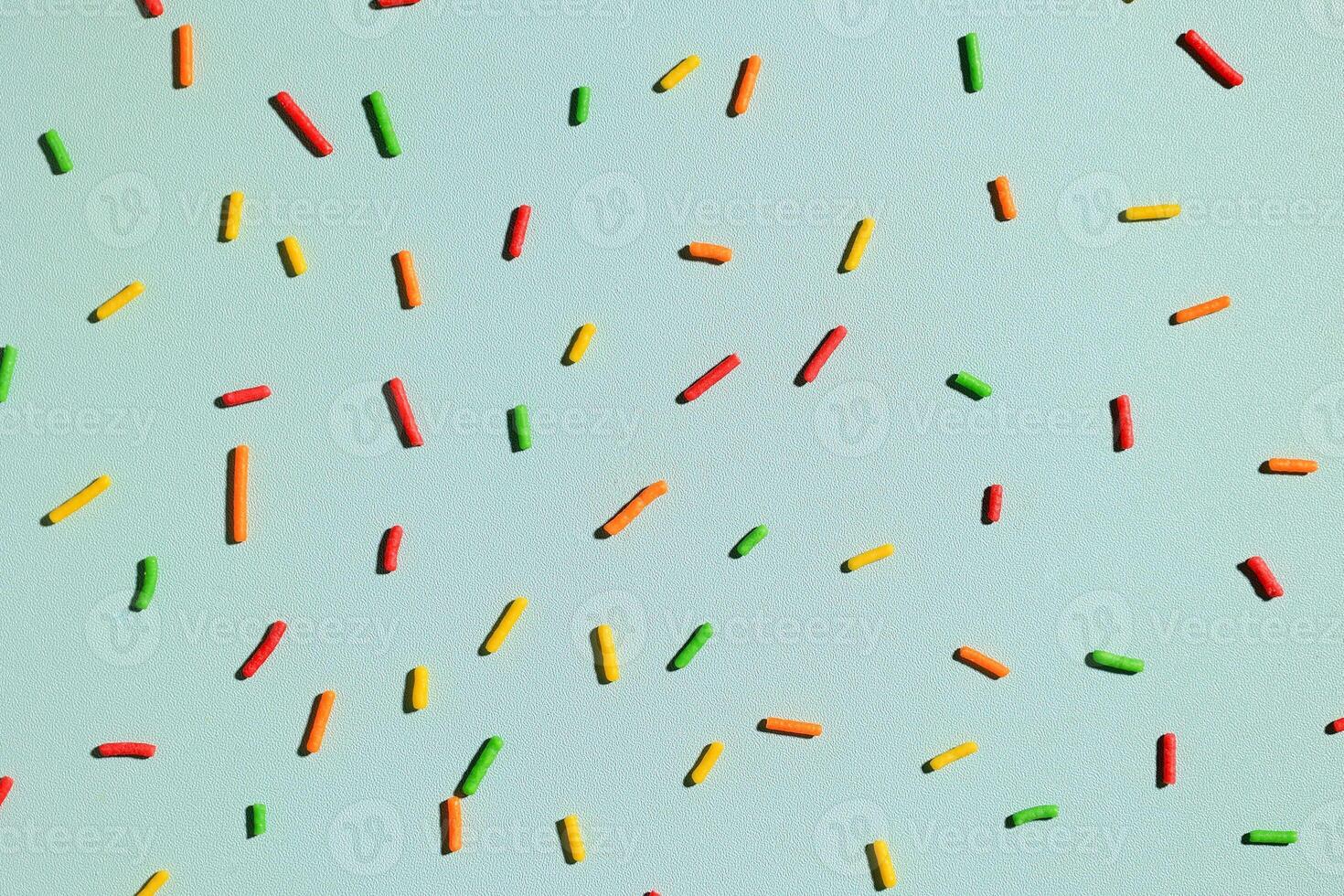 Pattern of Colorful Sprinkles with Hard Shadow on Mint Background, photo