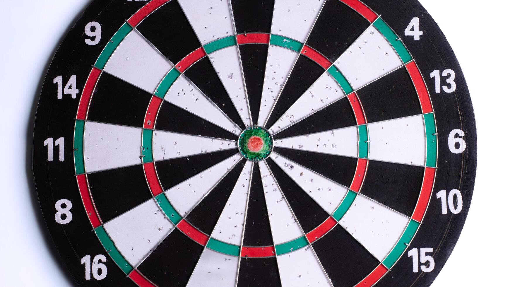 Close up of dartboard bullseye on white background. Focus and precision concept, target for darts game, competition, success, strategy, goal achievement. Isolated sports equipment. photo