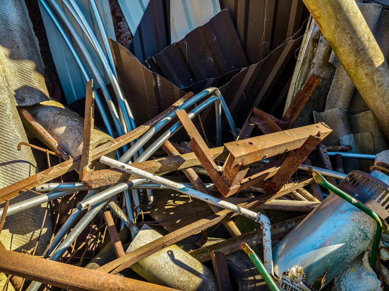A pile of junk with a lot of metal and wires. Scene is chaotic and disorganized photo