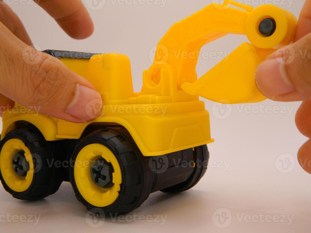Photo of contruction vehicle toy Excavator with hand. Can be used for t-shirt print, kids wear fashion design