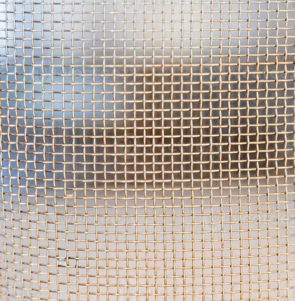 grid with a pattern of numerous small shaped cells, close view photo