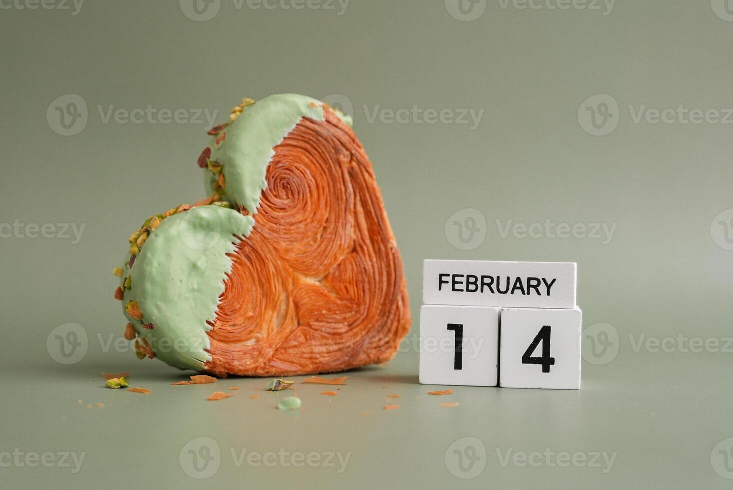 14 February love symbol Delicious fresh croissant topped with Matcha Green Tea flavor Ganache. Creation unique heart shape bakery. Puff pastry holiday love gift present idea Valentine's day. Copy space photo