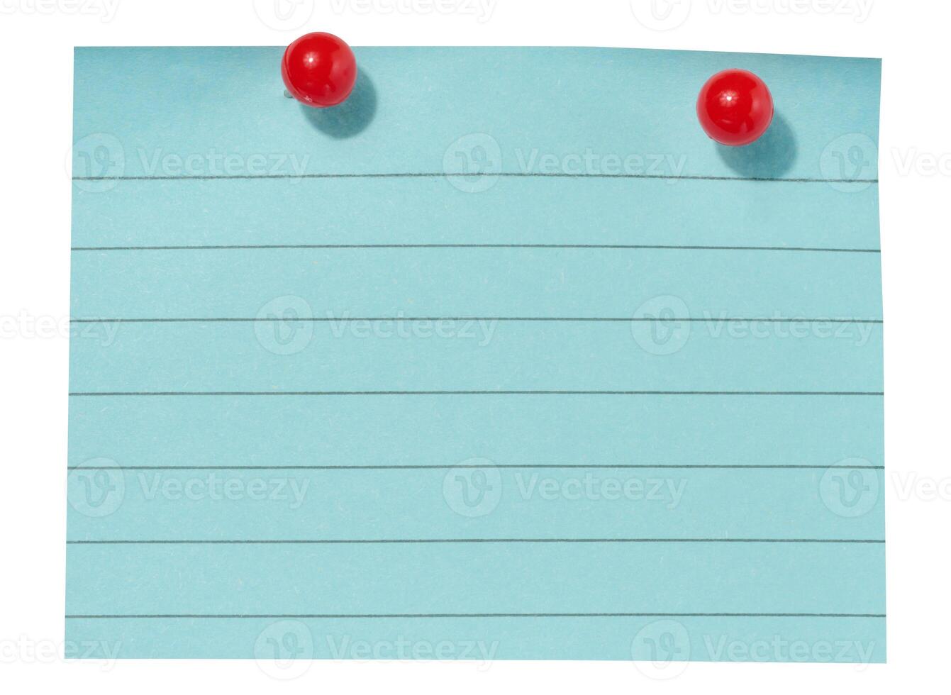 A sheet of blue lined paper attached with two red pushpins on an isolated background photo