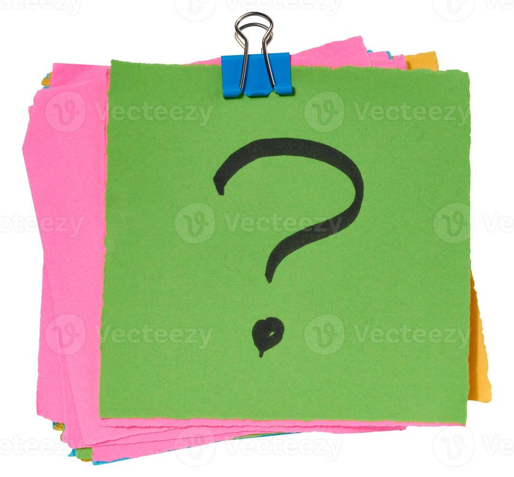 Stack of multicolored sticky notes with a black question mark drawn on the top green sticky note, secured with a blue paper clip. photo