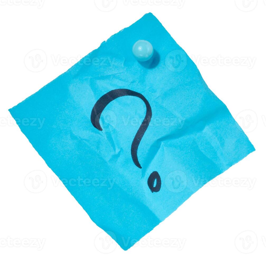 Crumpled sheet of blue paper with a black question mark drawn on it, attached with a blue pushpin, isolated background photo