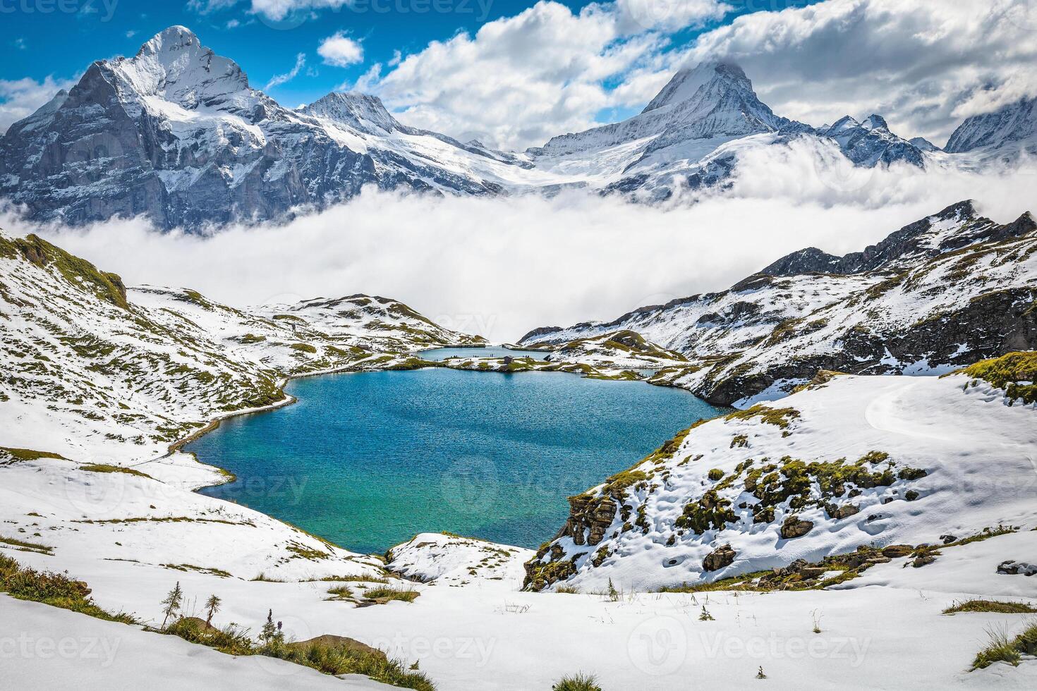 Bachalpsee lake and snow covered mountains in background, Grindelwald, Switzerland photo