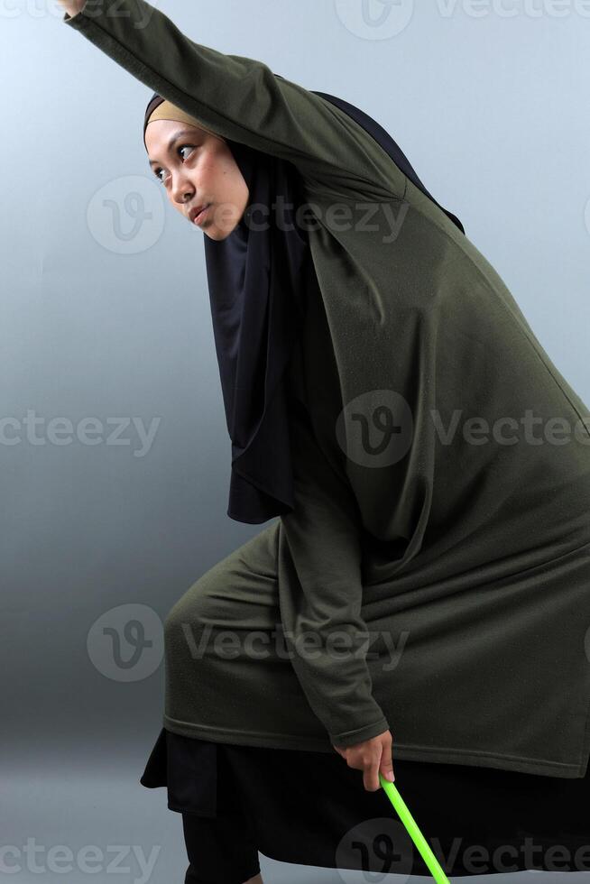 A Beautiful Asian Muslim Woman Wearing a Hijab Doing Poundfit Rock It Pose for Workout photo