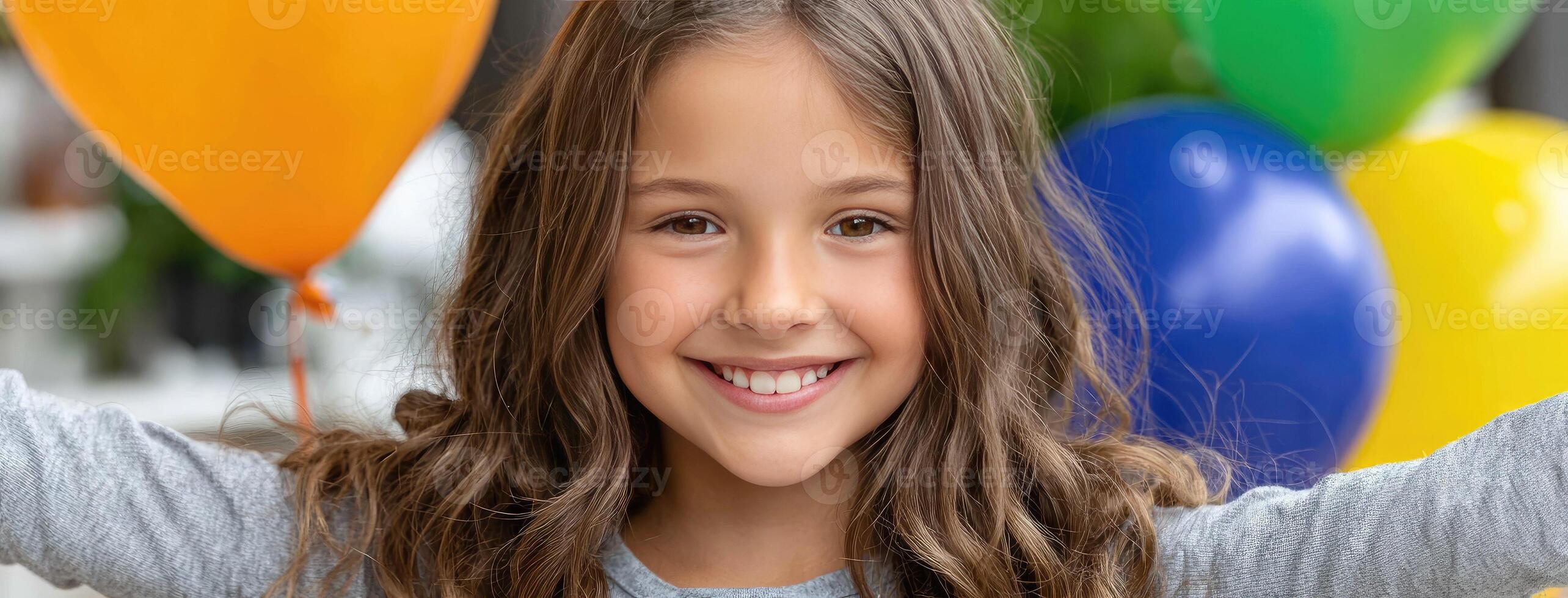 A young girl is smiling with her arms up in the air photo