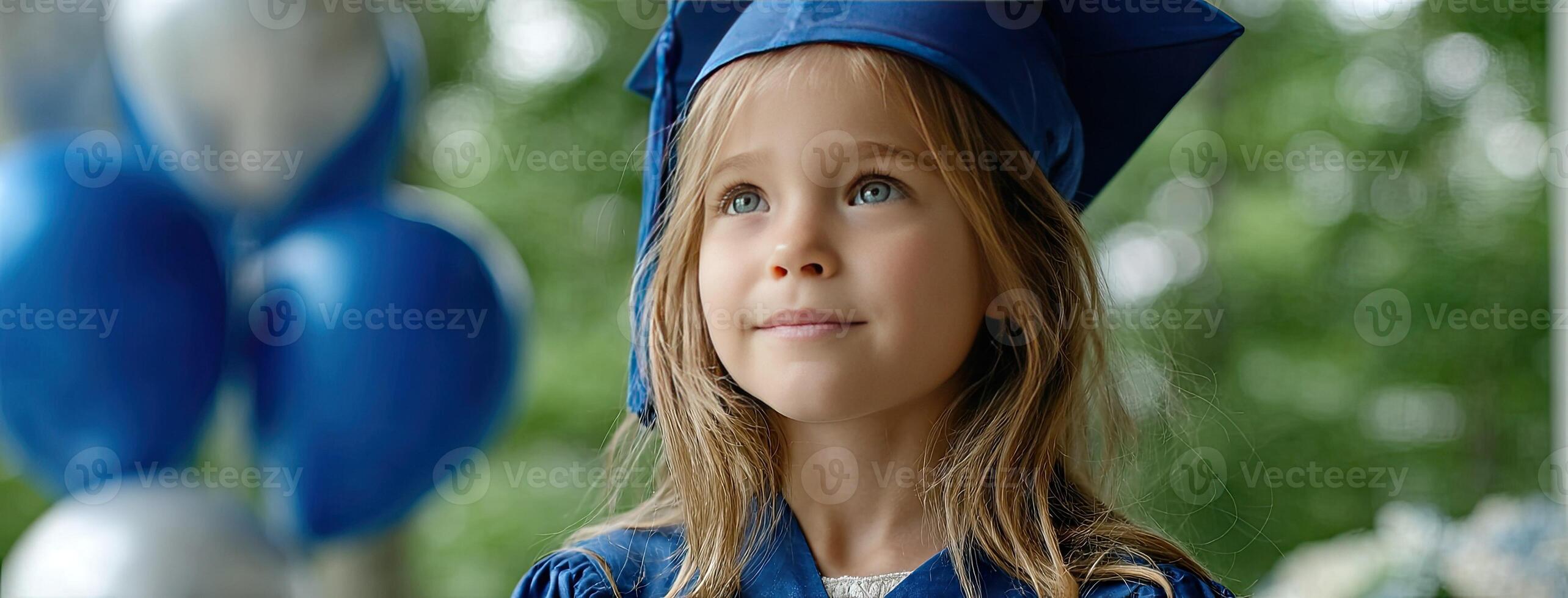 A young girl wearing a graduation cap and gown photo