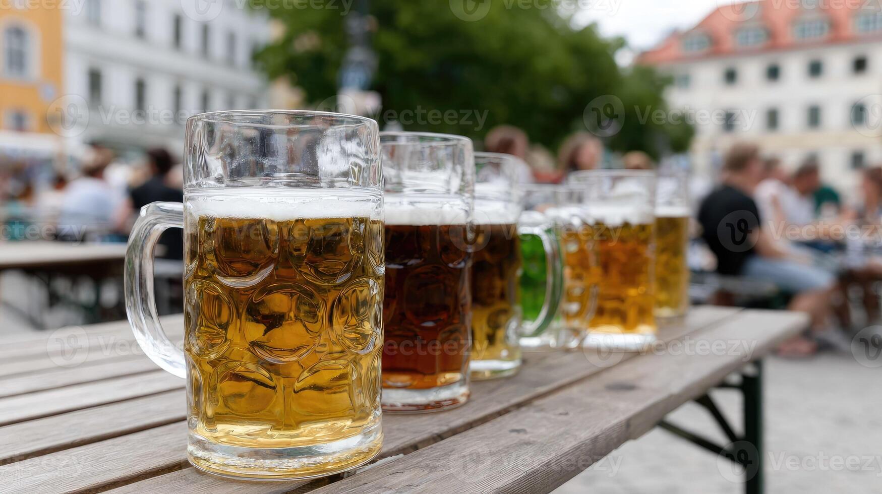 Beer mugs lined up on a wooden table photo