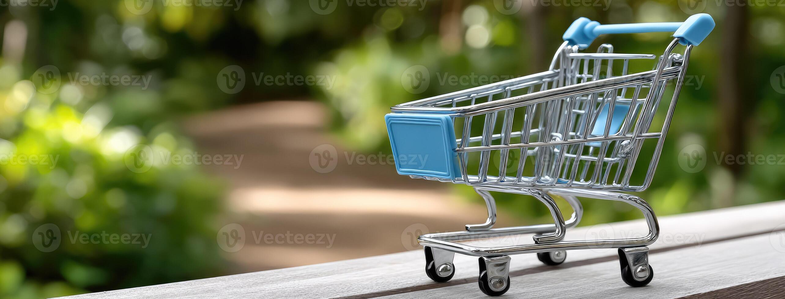 A small shopping cart is sitting on a wooden bench photo