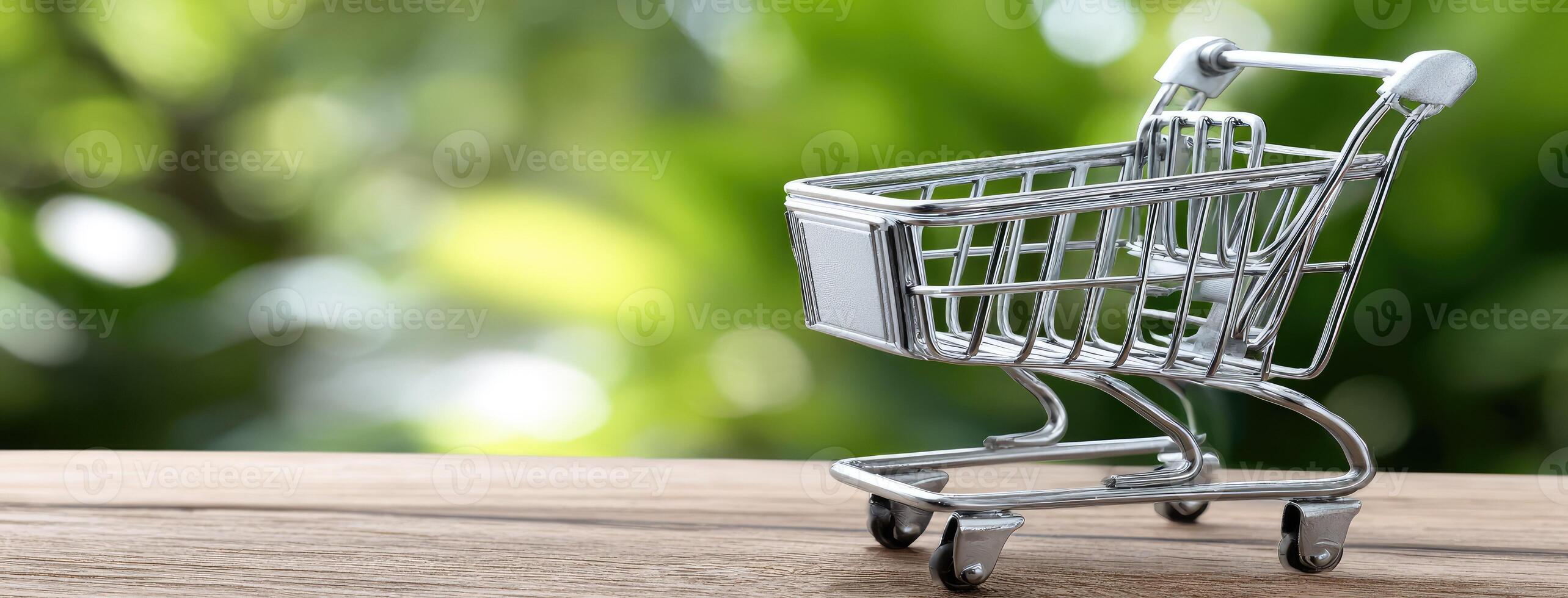 A small shopping cart on a wooden table photo