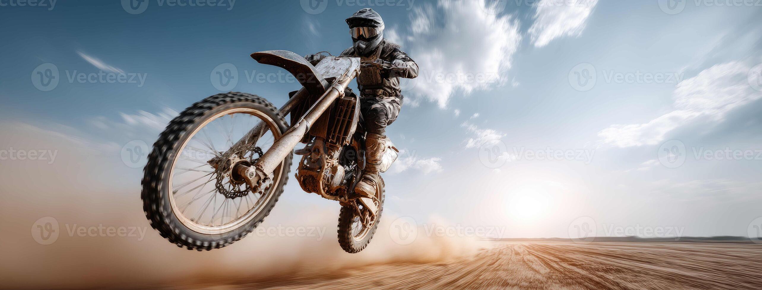 Motocross rider on dirt bike in the air photo