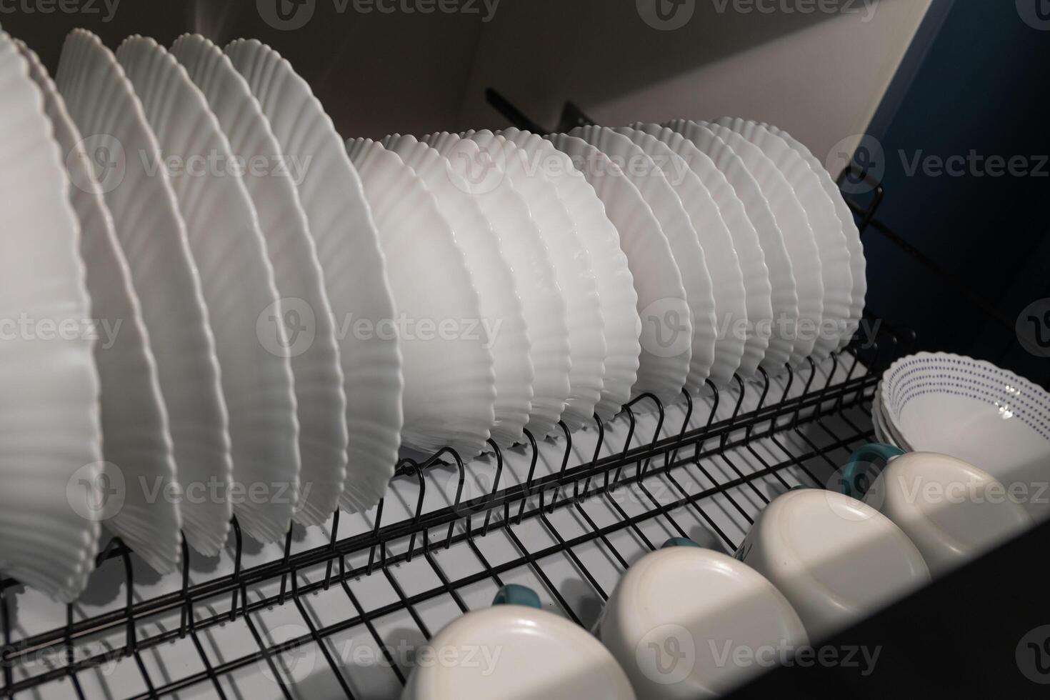 Dishes Drying in a Kitchen Rack After a Wash in a Modern Home photo