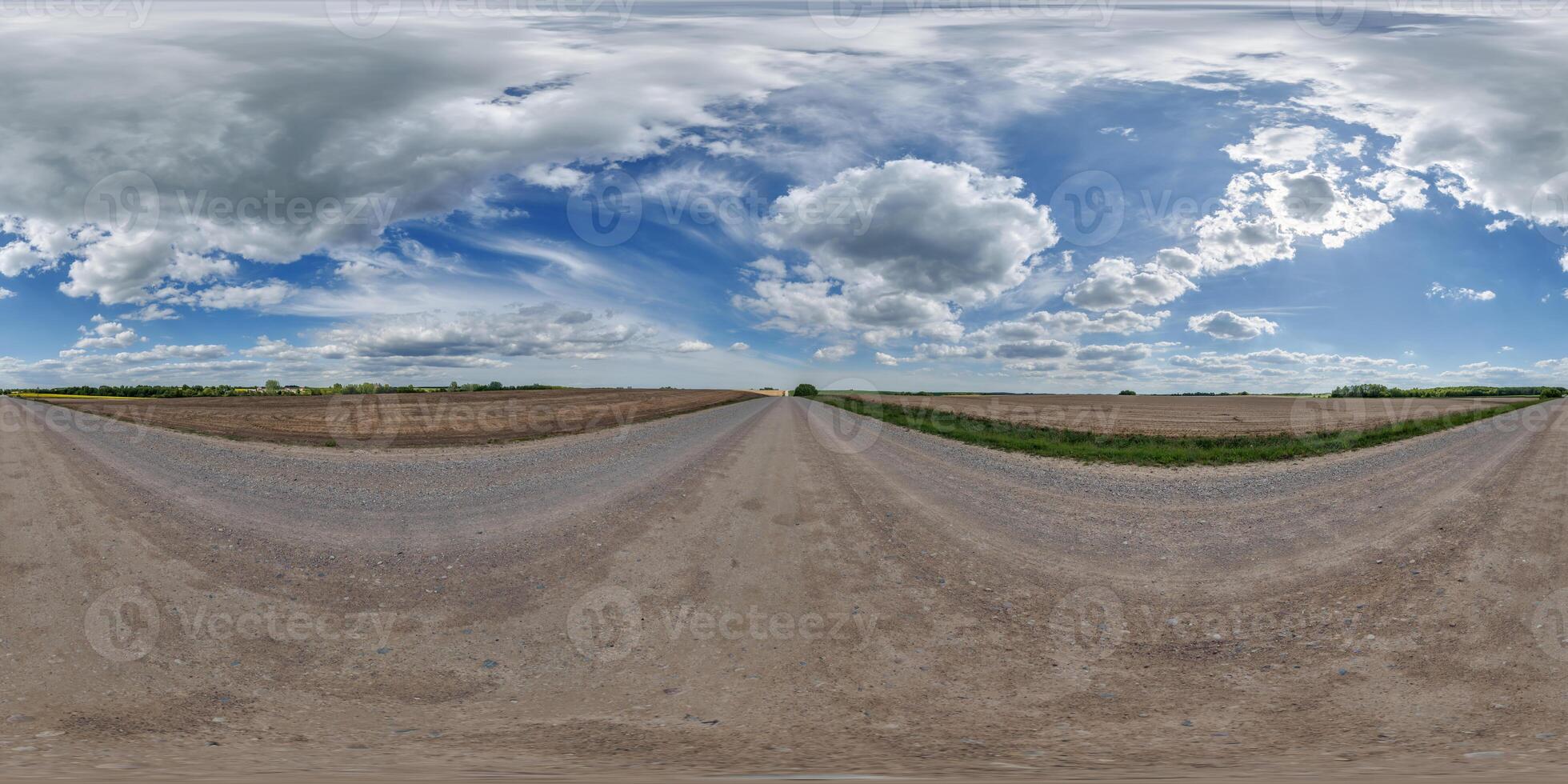 hdri 360 panorama view on gravel road among fields with clouds in sky in equirectangular full seamless spherical projection, ready for VR AR or sky dome replacement photo