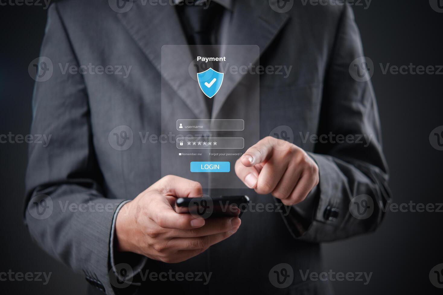Businessman in suit holding smartphone with security icon on screen photo