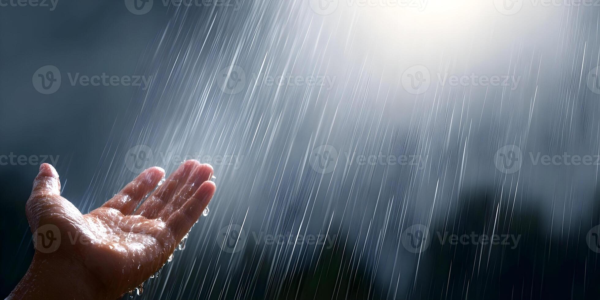 Hand catching raindrops in a peaceful nature scene photo