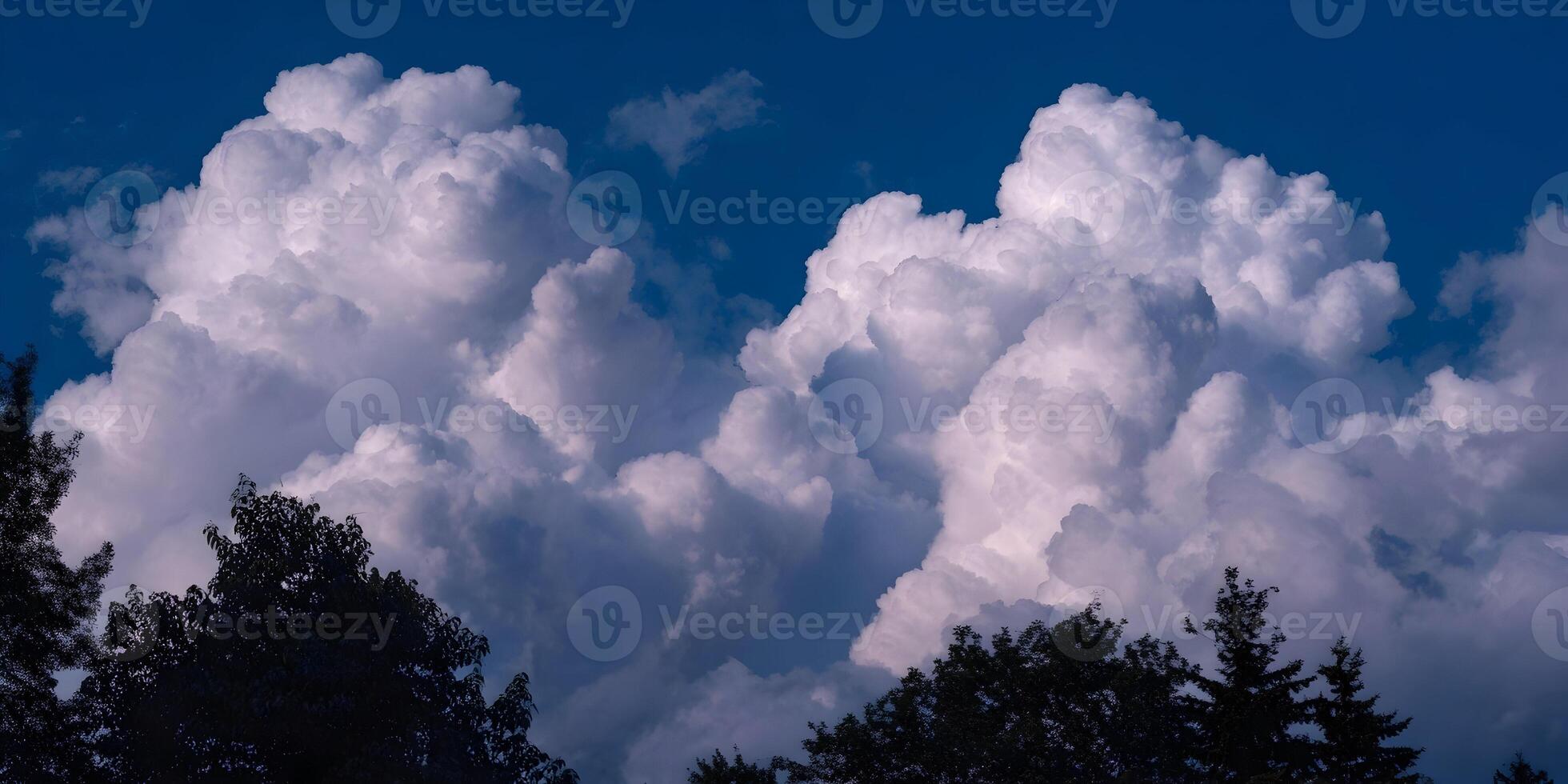 Large Cumulus Cloudscape Over Silhouetted Trees Blue Sky Background photo