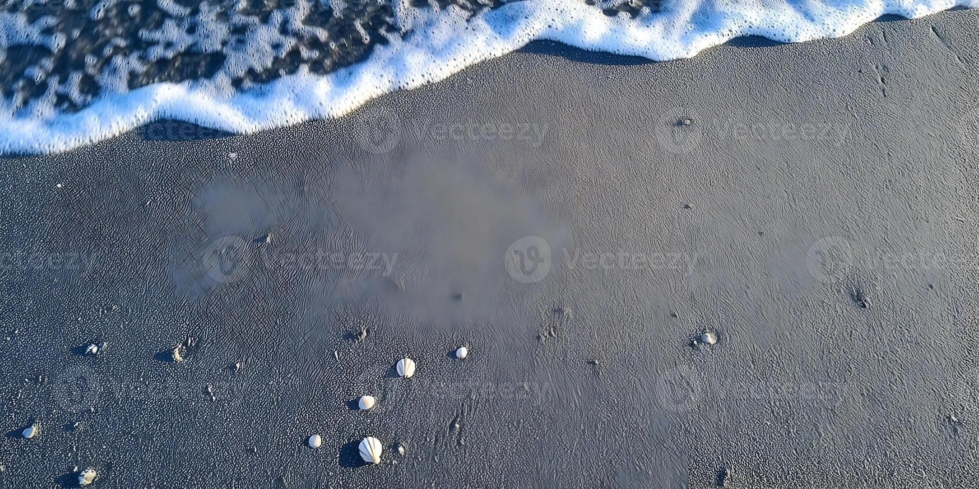 Ocean Wave on Dark Sand Beach with Small Shells photo
