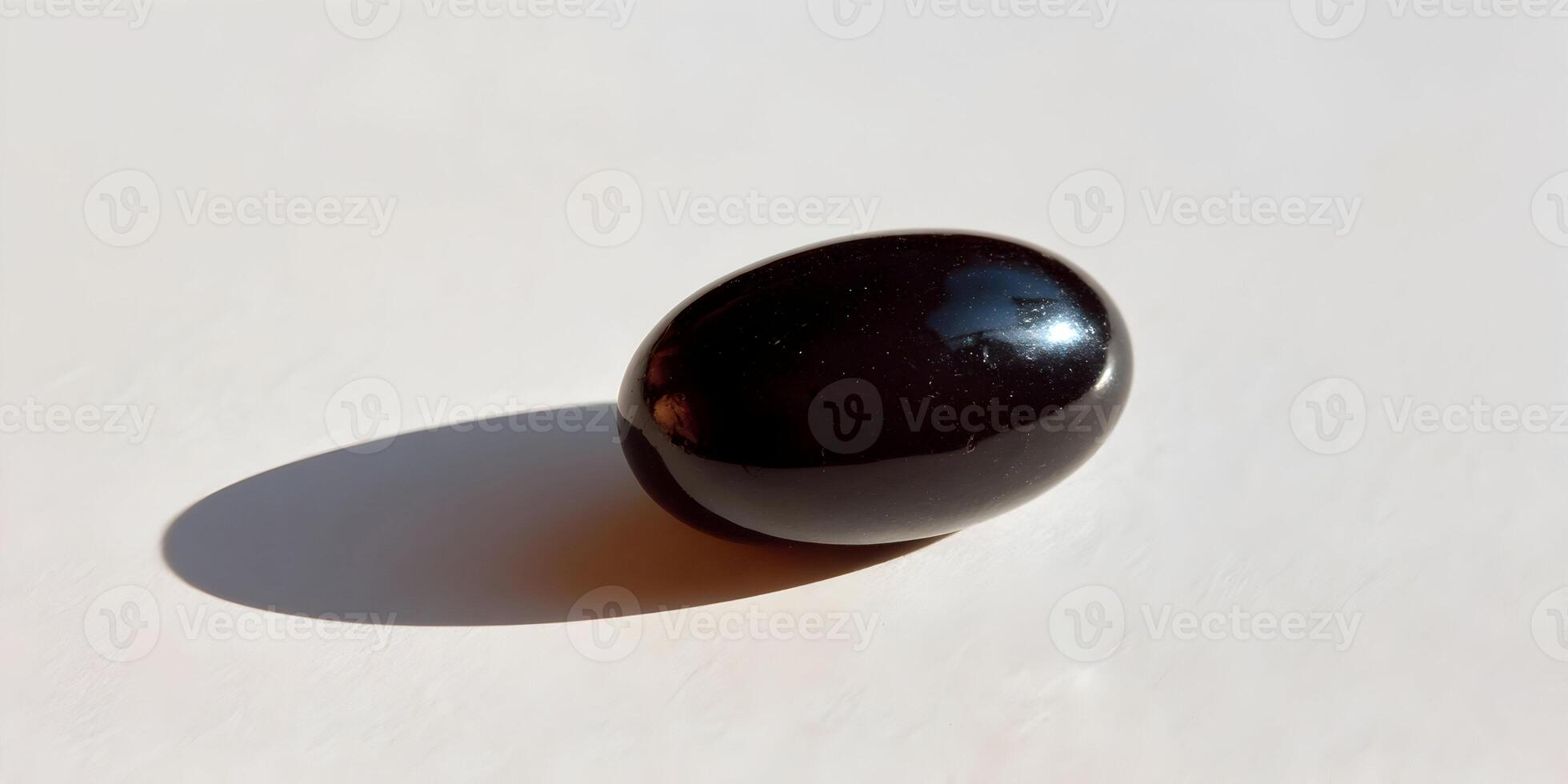 Single Black Capsule Pill on White Background Closeup Photography photo