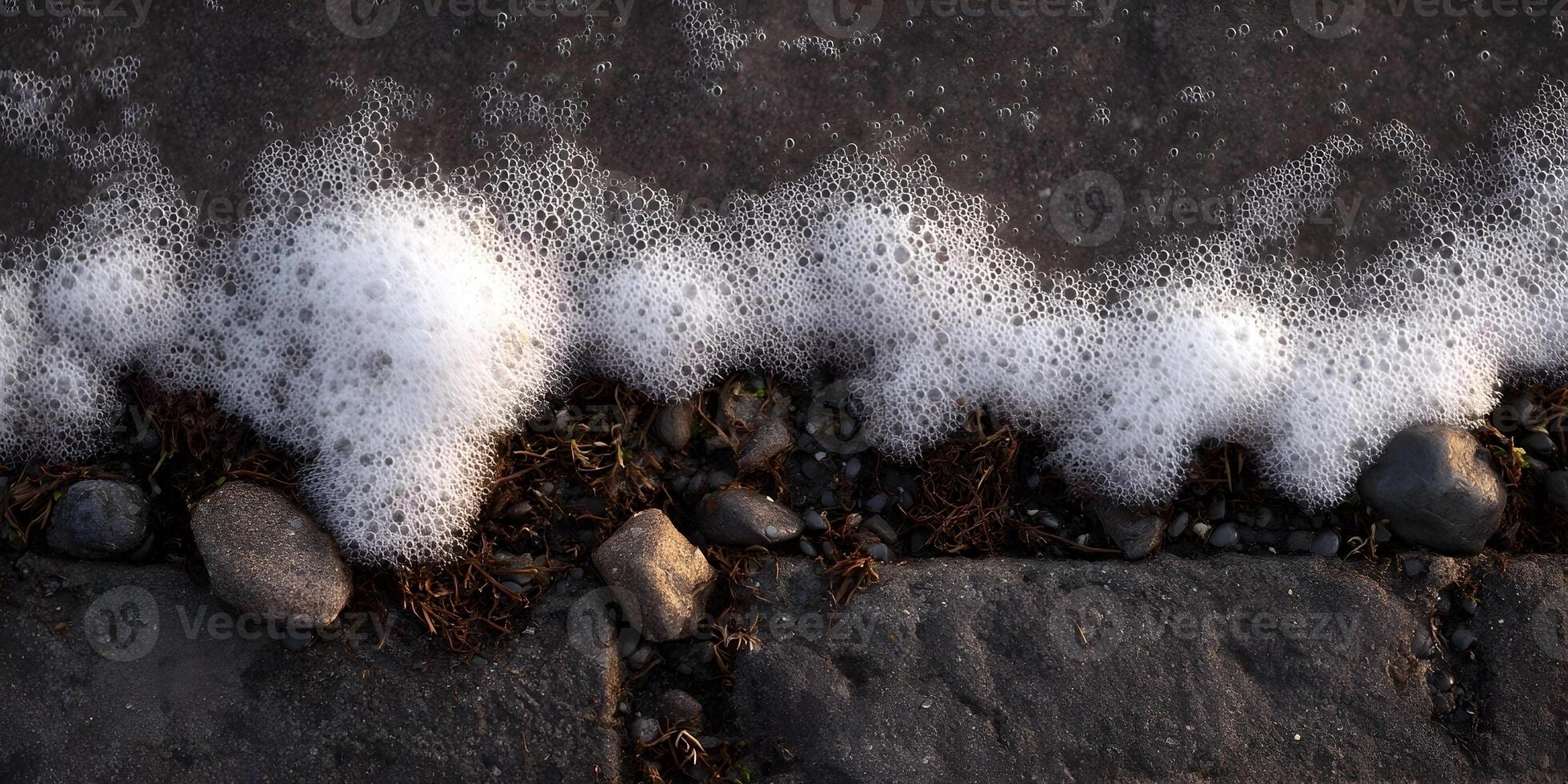 Ocean Waves Foam on Dark Sand Beach Rocks photo