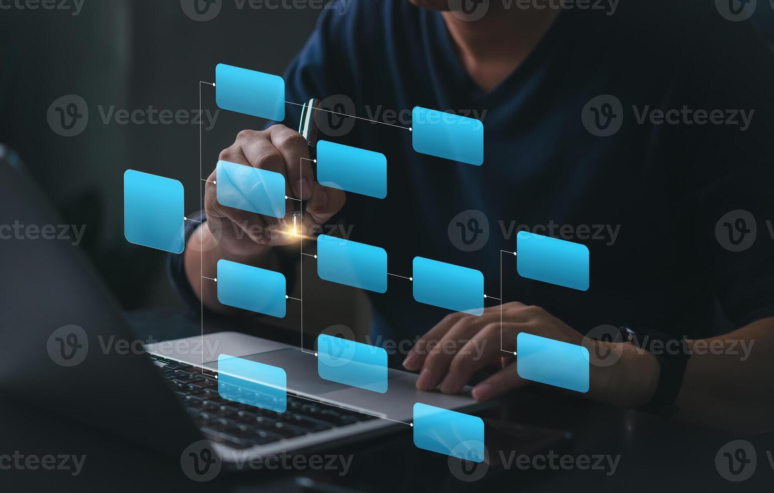 Man using laptop with blue icons on screen photo