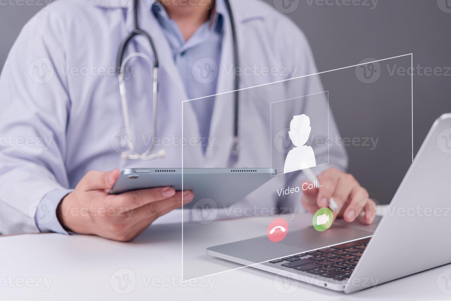 A doctor is using a laptop with a patient on the screen photo