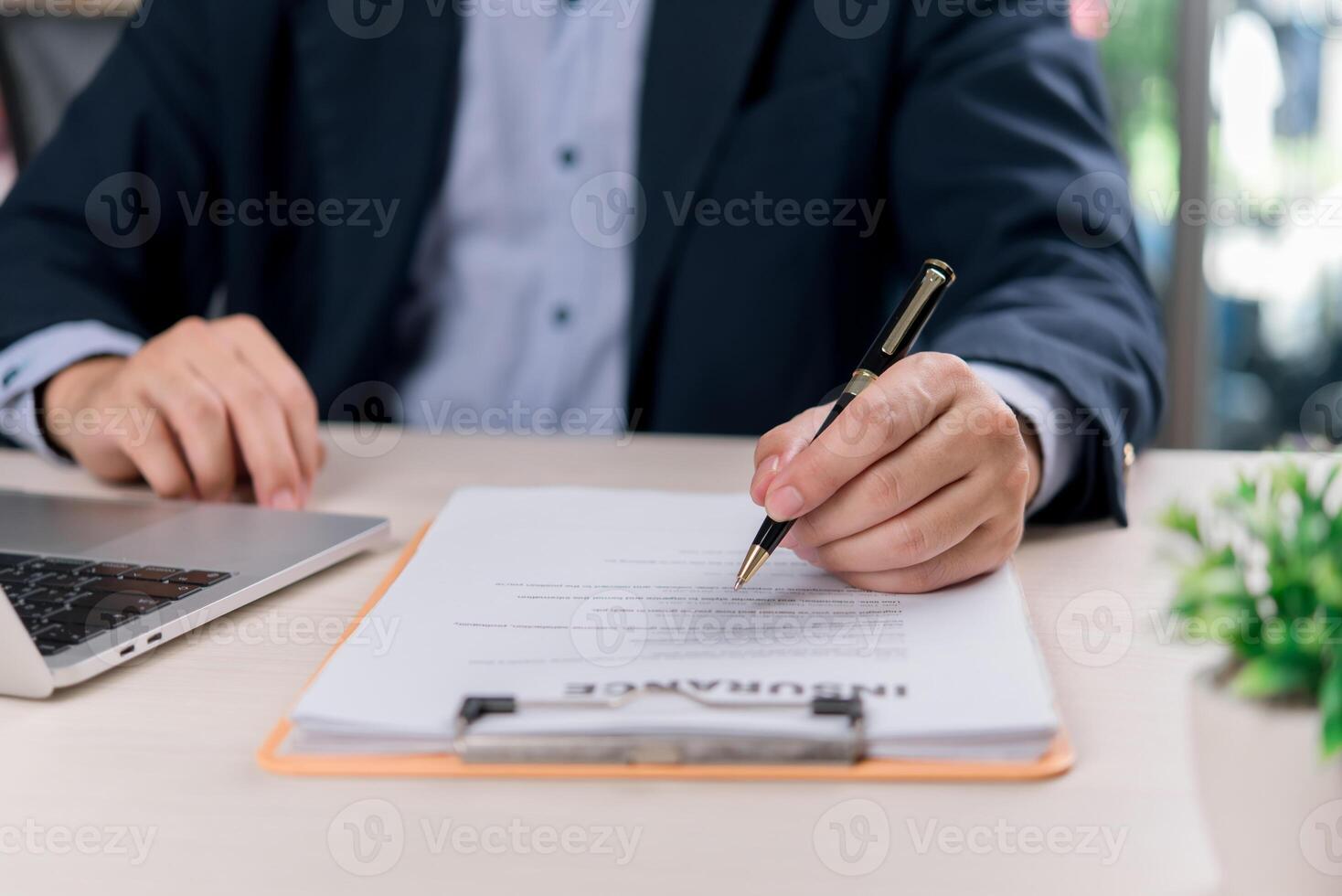 Businessman signing contract at office desk photo