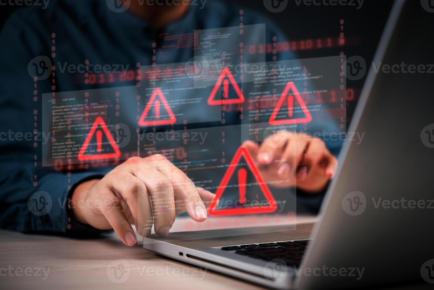 Cyber security and hacking concept - man using laptop with red warning icons on screen photo