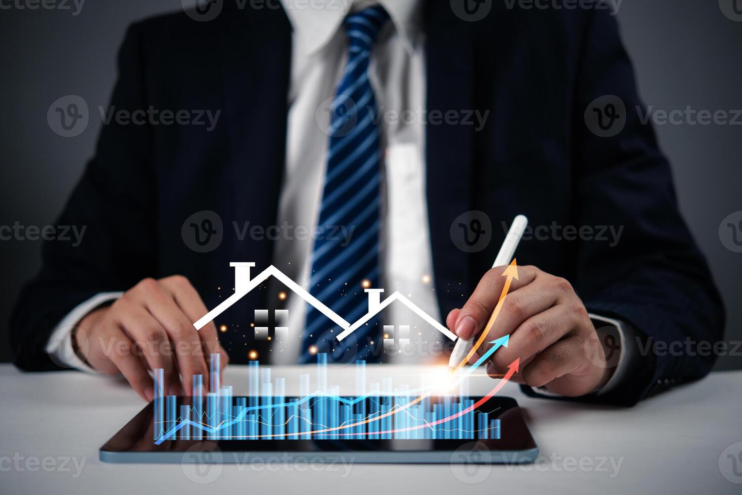 Businessman using tablet with graph and business chart photo