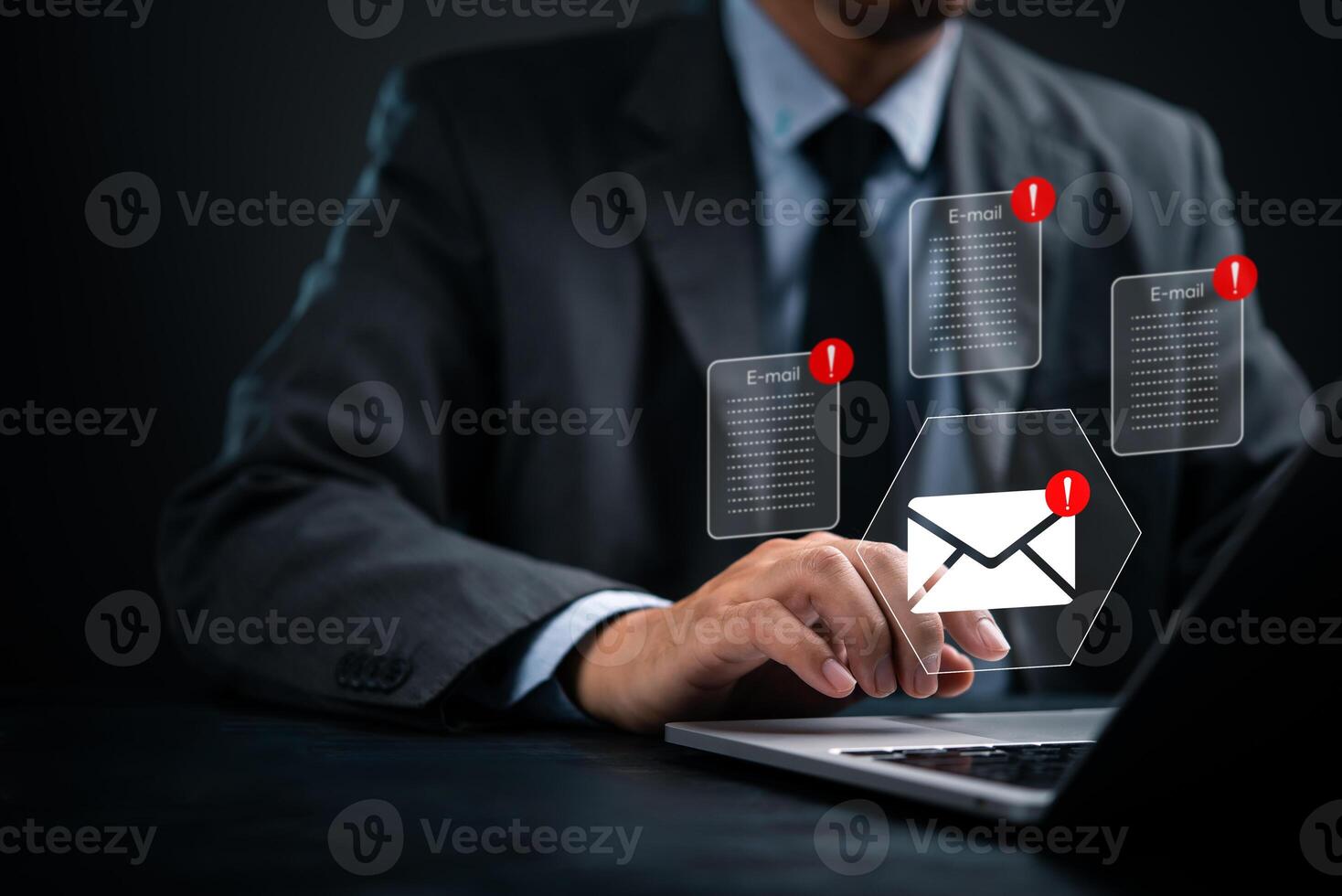 Businessman using laptop with email icons on screen photo
