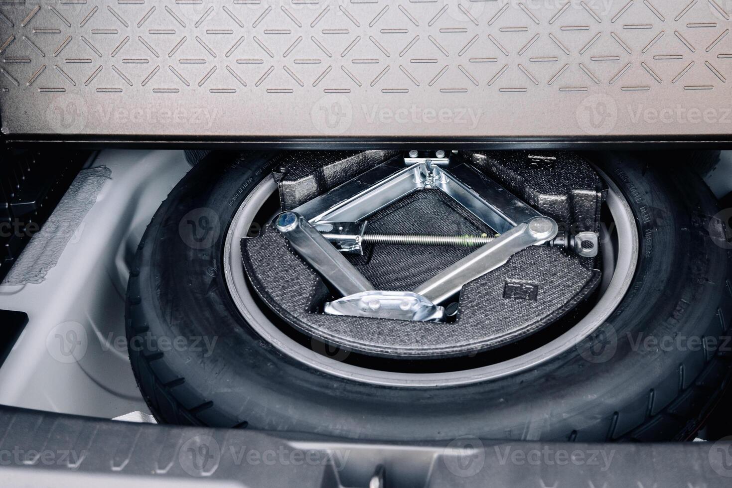 Spare wheel in the trunk of a modern car photo