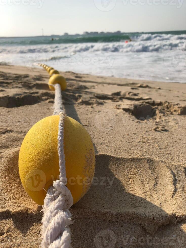 Small yellow buoy on a beach in Dubai 10 photo